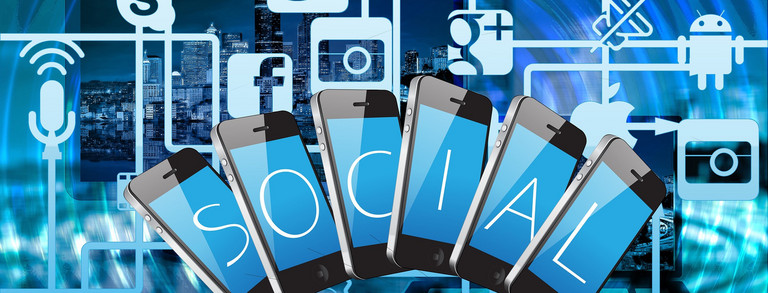 Several cell phones fanned out next to each other, each with a letter on its display. All the letters together make up the word "social". Lines connected to the cell phones lead to social media icons.
